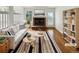 Bright living room with a fireplace, striped rug and modern furniture at 8536 S Upham Way, Littleton, CO 80128