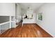 Open-concept living room with hardwood floors and a breakfast bar at 8536 S Upham Way, Littleton, CO 80128