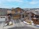 Aerial view of a two-story home featuring a two-car garage, covered front porch, and landscaped yard at 6731 Pinery Villa Pl, Parker, CO 80134