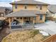 A covered patio with outdoor seating complements the backyard's fenced perimeter at 6731 Pinery Villa Pl, Parker, CO 80134