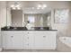 Bright bathroom featuring double vanity, granite countertop, large mirror, and separate shower at 6731 Pinery Villa Pl, Parker, CO 80134