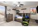 Neutral bedroom featuring a wood bed frame with storage, dark wood dresser, and ceiling fan at 6731 Pinery Villa Pl, Parker, CO 80134