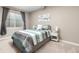 Cozy bedroom with carpet, a window, and stylishly decorated with blue and gray striped bedding and a bedside table at 6731 Pinery Villa Pl, Parker, CO 80134