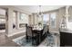 Elegant dining room featuring a fireplace, modern chandelier, and a table set for eight guests at 6731 Pinery Villa Pl, Parker, CO 80134