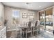 Elegant dining room with stylish chandelier, large windows, and easy access to the outdoor living space at 6731 Pinery Villa Pl, Parker, CO 80134