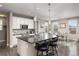 Open kitchen with a center island, pendant lighting, and seamless connection to the dining area at 6731 Pinery Villa Pl, Parker, CO 80134