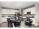 Modern kitchen with white cabinets, stainless steel appliances, granite countertops, and a spacious island at 6731 Pinery Villa Pl, Parker, CO 80134