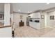 Basement kitchenette with white cabinetry, stainless steel appliances, and bar seating at 6731 Pinery Villa Pl, Parker, CO 80134