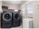 Laundry room featuring side-by-side washer and dryer, storage cabinet, and bright natural light at 6731 Pinery Villa Pl, Parker, CO 80134