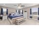 Spacious bedroom with a tufted headboard, blue bedding, and a dresser with a television at 6731 Pinery Villa Pl, Parker, CO 80134