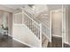 Elegant staircase with white railings, carpeted steps, and a stylish table at the landing at 6731 Pinery Villa Pl, Parker, CO 80134