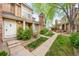 Charming townhouse exterior with well-maintained landscaping, brick chimney, and inviting entrance, nestled in a friendly community at 14343 E Dickinson Dr # E, Aurora, CO 80014