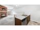 Kitchen with stainless steel appliances, wooden cabinets, and a breakfast bar overlooking the living area at 14343 E Dickinson Dr # E, Aurora, CO 80014