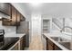 Modern kitchen with updated appliances, wooden cabinets, and stairs to the upper level of the home at 14343 E Dickinson Dr # E, Aurora, CO 80014