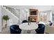 Bright living room features modern furniture, including blue chairs, fireplace, and stairs to the upper level at 14343 E Dickinson Dr # E, Aurora, CO 80014