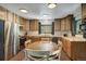 Kitchen features stainless steel appliances, wood cabinets, and a dining table at 324 County Road 672, Breckenridge, CO 80424