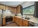Kitchen featuring stainless steel appliances, wood cabinets, and a large window at 324 County Road 672, Breckenridge, CO 80424
