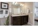 Bathroom featuring a double sink vanity with dark wood cabinets and modern fixtures at 6905 Fraser Cir, Frederick, CO 80530