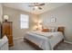 Cozy bedroom with a comfortable bed, ceiling fan, and ample natural light at 6905 Fraser Cir, Frederick, CO 80530