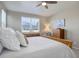 Bedroom with natural light, ceiling fan, dresser, and comfortable bed at 6905 Fraser Cir, Frederick, CO 80530