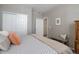 Well-lit bedroom featuring a comfortable bed, closet, and a striped bench at 6905 Fraser Cir, Frederick, CO 80530