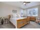 Bedroom features a wooden bed frame, dresser, and windows with blinds at 6905 Fraser Cir, Frederick, CO 80530