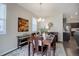 Elegant dining room with neutral walls, seating for six and direct access to the kitchen at 6905 Fraser Cir, Frederick, CO 80530