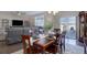 Well-lit dining room featuring a wooden table and seating for six, adjacent to a living room at 6905 Fraser Cir, Frederick, CO 80530