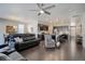 Open-concept living room and kitchen features hardwood floors and a ceiling fan at 6905 Fraser Cir, Frederick, CO 80530