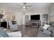 Living room with hardwood floors, fireplace, and comfortable seating at 6905 Fraser Cir, Frederick, CO 80530