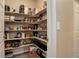 Walk-in pantry with lots of shelving for storage, accessible from kitchen at 6905 Fraser Cir, Frederick, CO 80530