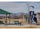 A neighborhood playground featuring slides and picnic tables sits at the base of the mountains at 6905 Fraser Cir, Frederick, CO 80530