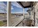 Inviting covered porch featuring comfortable seating and views of the neighborhood and distant mountains at 6905 Fraser Cir, Frederick, CO 80530