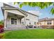 The backyard has a covered patio, outdoor dining, a playhouse, and a lush green lawn at 6520 Empire Ave, Frederick, CO 80516