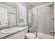 Bright bathroom featuring tiled shower with glass door, granite counters, and a modern vanity at 6520 Empire Ave, Frederick, CO 80516