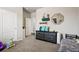 Bedroom featuring neutral-colored walls, carpet, a dresser, and wall decor at 6520 Empire Ave, Frederick, CO 80516