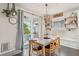 Bright dining area featuring a modern light fixture, sliding glass doors to the outdoor patio, and shelving at 6520 Empire Ave, Frederick, CO 80516