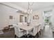 Dining area with wood floors, chandelier and palm tree themed wall art at 6520 Empire Ave, Frederick, CO 80516