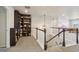 Hallway featuring built in bookshelves and a stairway at 6520 Empire Ave, Frederick, CO 80516