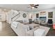 Open living room with hardwood floors, ceiling fan and a staircase leading to the second floor at 6520 Empire Ave, Frederick, CO 80516