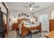Comfortable main bedroom with a large bed, ceiling fan, bedside tables, and natural lighting at 6520 Empire Ave, Frederick, CO 80516