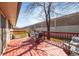 Inviting back deck with red wood features outdoor seating and a lush lawn at 8210 W 72Nd Pl, Arvada, CO 80005