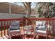 Outdoor back deck setup with chairs and a small table, great for enjoying evenings at 8210 W 72Nd Pl, Arvada, CO 80005