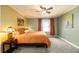 Cozy bedroom featuring soft carpeting, a ceiling fan, and a warm color scheme at 8210 W 72Nd Pl, Arvada, CO 80005