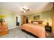 Bright bedroom features a ceiling fan, and access to a walk-in closet and an ensuite bathroom at 8210 W 72Nd Pl, Arvada, CO 80005