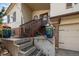 View of a house's front porch with wooden stairs and flower-filled planters at 8210 W 72Nd Pl, Arvada, CO 80005