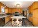Well-equipped kitchen with wooden cabinets, an island with stools, and ample counter space at 8210 W 72Nd Pl, Arvada, CO 80005