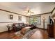 Inviting living room with beautiful hardwood floors, large window, and a ceiling fan at 8210 W 72Nd Pl, Arvada, CO 80005
