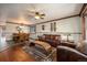 Open-concept living area with an adjacent dining space and hardwood floors at 8210 W 72Nd Pl, Arvada, CO 80005