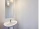 Simple bathroom with pedestal sink and mirror at 2345 Walnut St # 24, Denver, CO 80205
